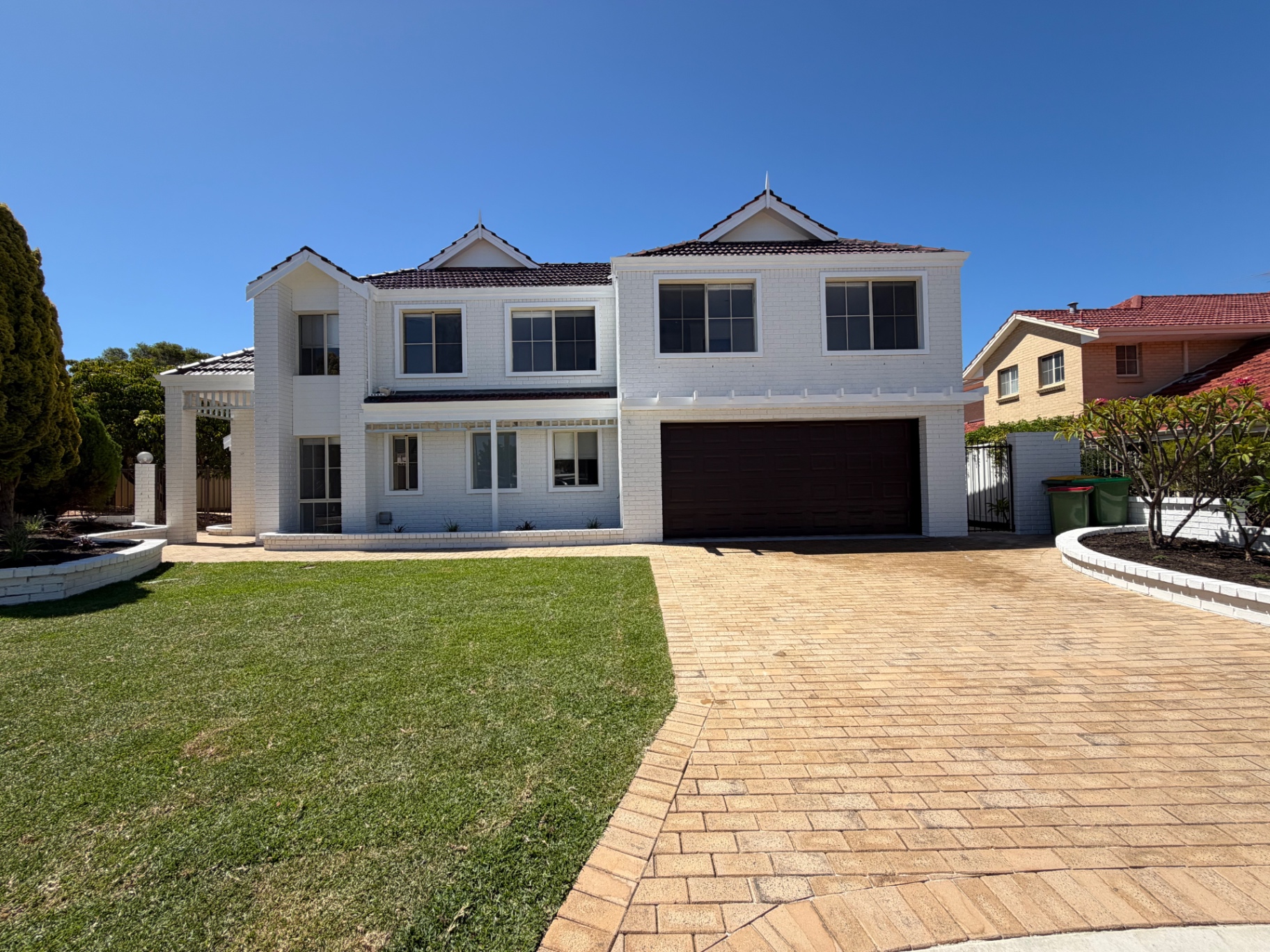 Two-storey white home with clean exterior